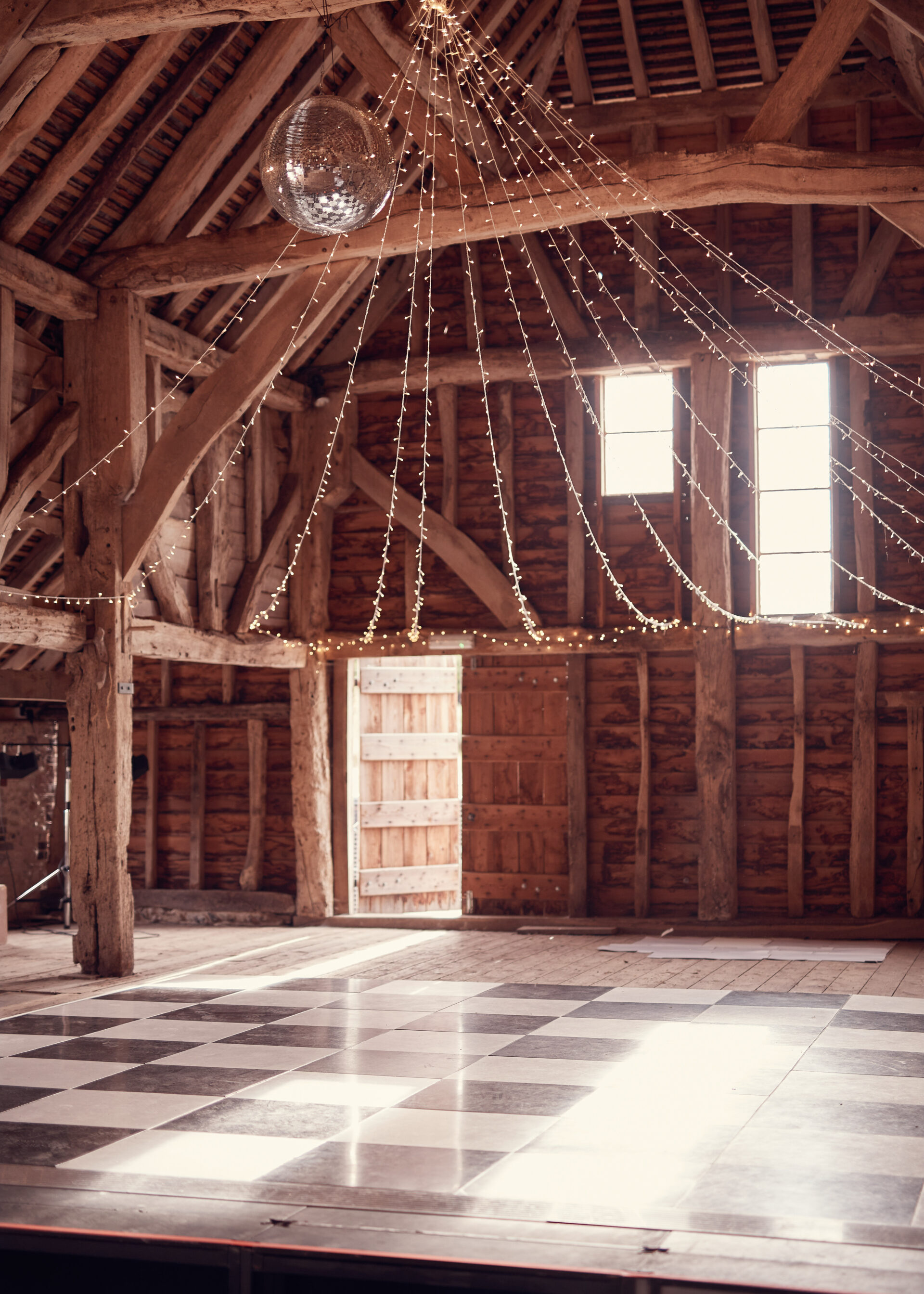 dancefloor and disco ball at countryside barn wedding at Sullington Manor Farm, West Sussex, RH20 4AE. DIY countryside barn wedding