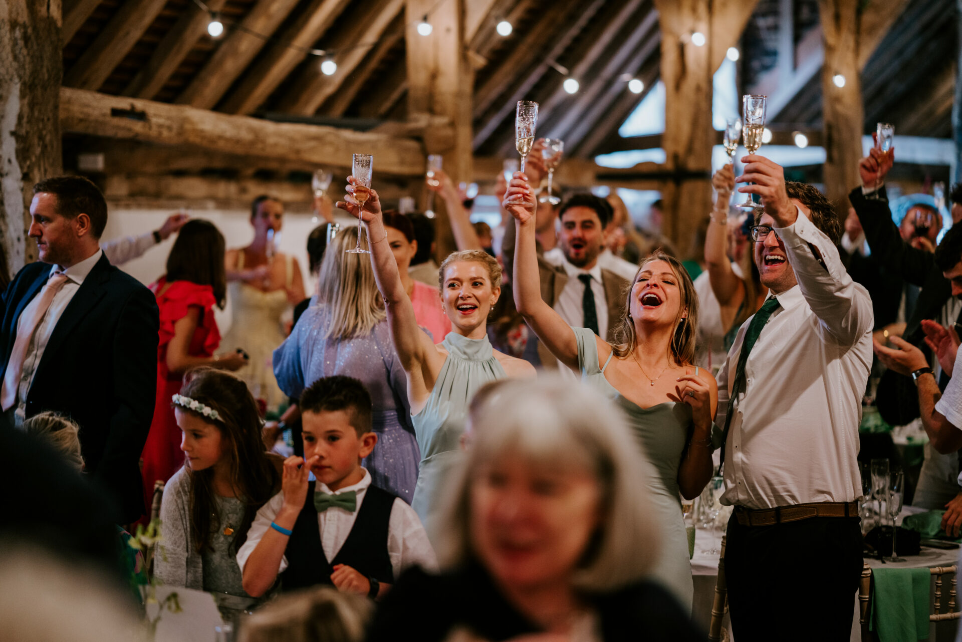 Friends and family at barn wedding at Sullington Manor Farm, West Sussex, RH20 4AE. Farm wedding in South Downs