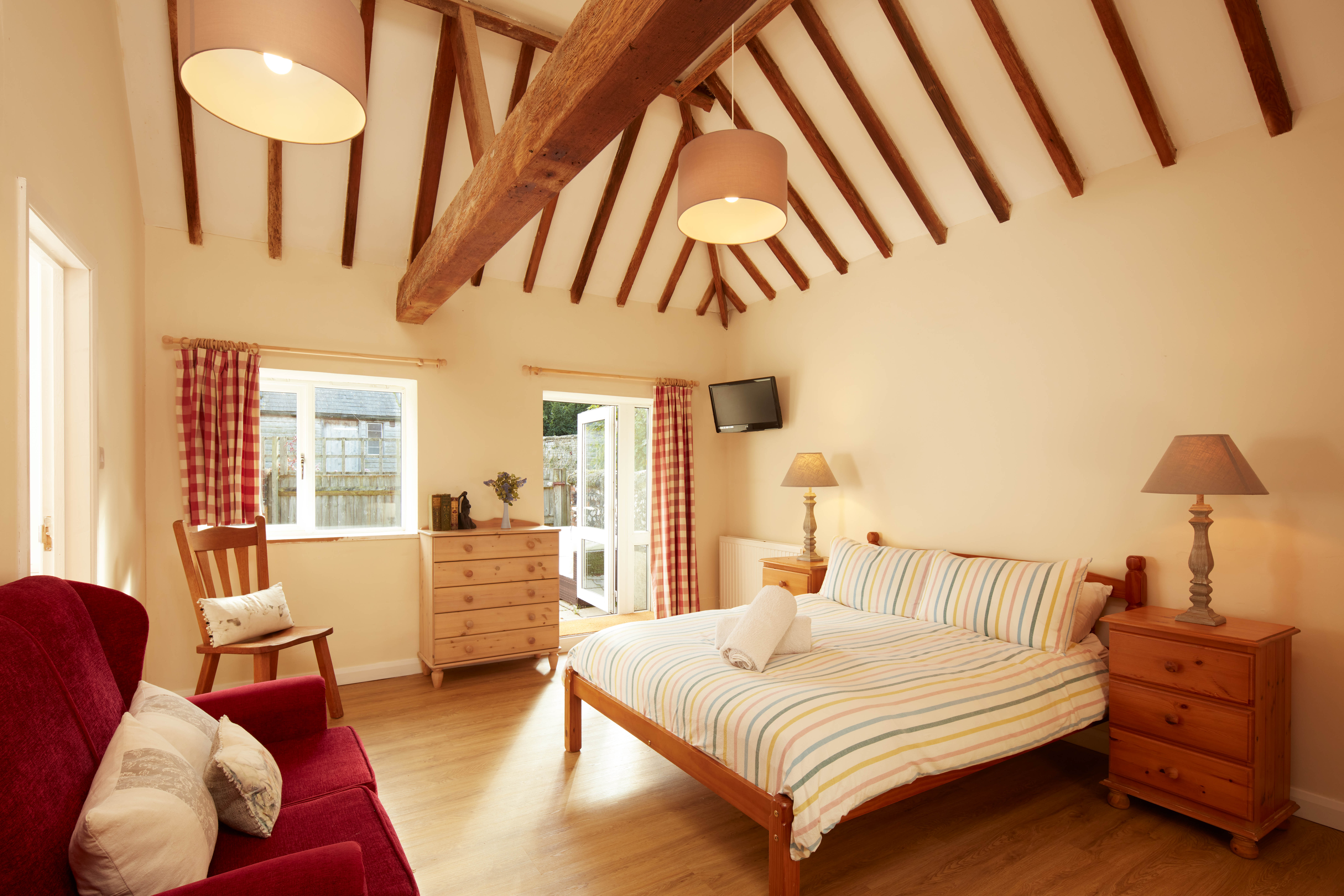 stay in beautiful Victorian beamed double room at Byre Cottages, Sullington Manor Farm, West Sussex, RH20 4AE. Self catering holiday cottages in middle of South Downs with tennis court and outdoor swimming pool